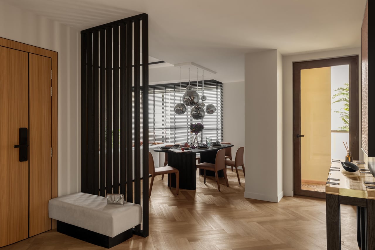 Entry and dining area with a slatted timber room divider, dark ribbed dining table and smoked-glass pendant lights